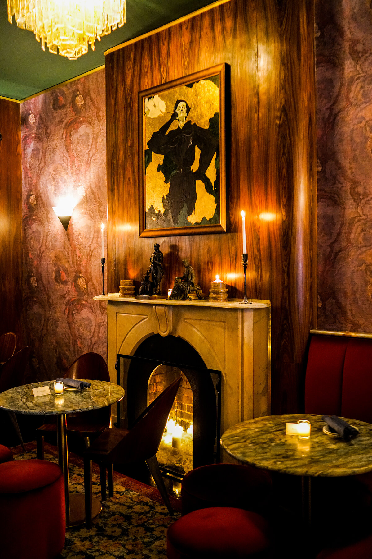 The bar at Jeremy's — fireplace, chandelier, and portrait